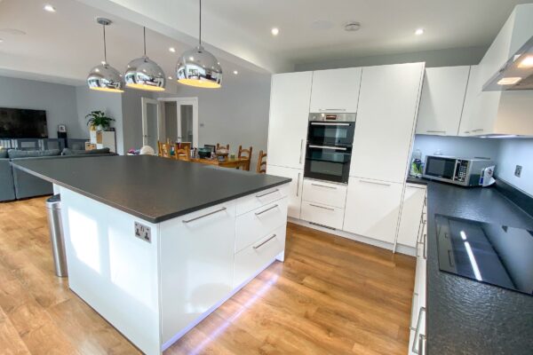 White U-Shaped Kitchen with Pendant Lighting