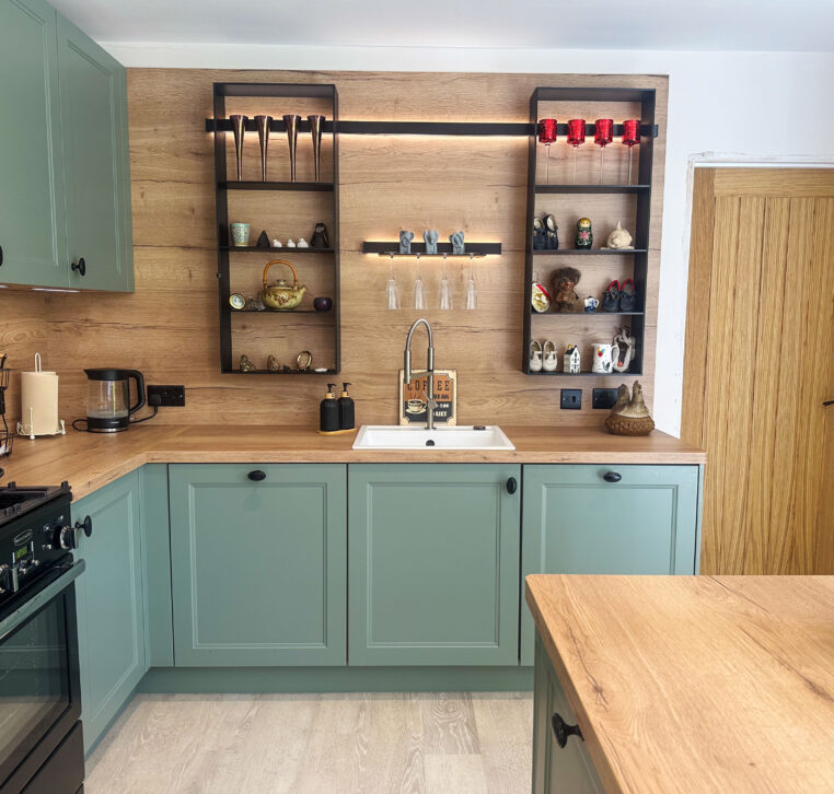 Wooden topped kitchen with green doors