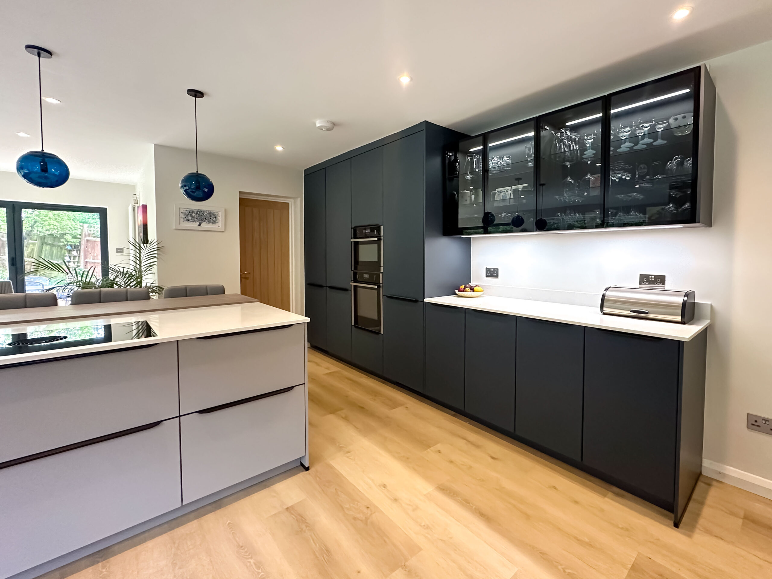 Elegant modern kitchen with matt grey cabinetry and a double oven.