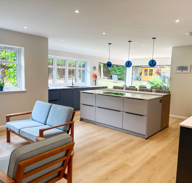Modern open-plan kitchen with grey cabinets and a spacious island in the center