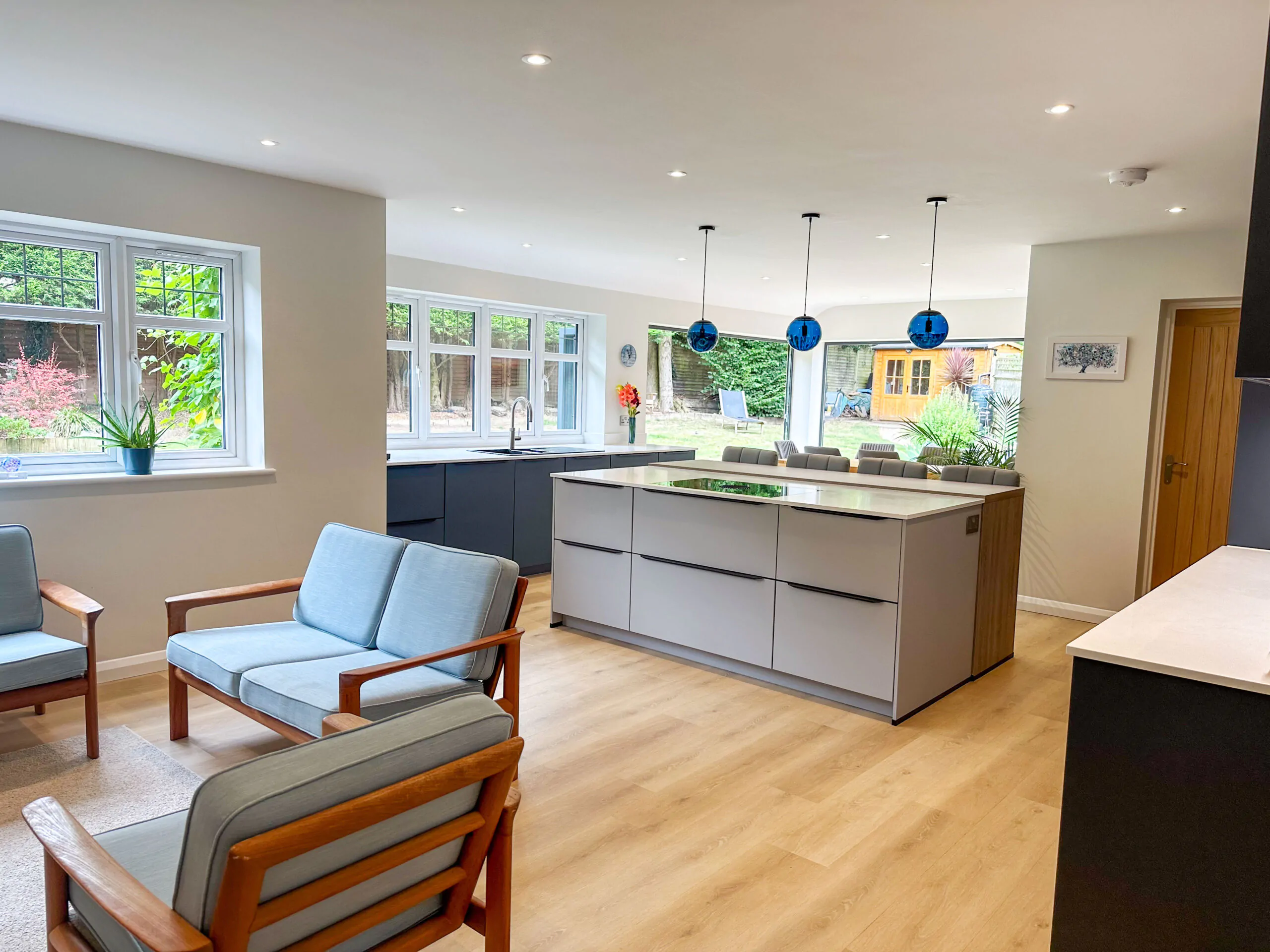 Modern open-plan kitchen with grey cabinets and a spacious island in the center