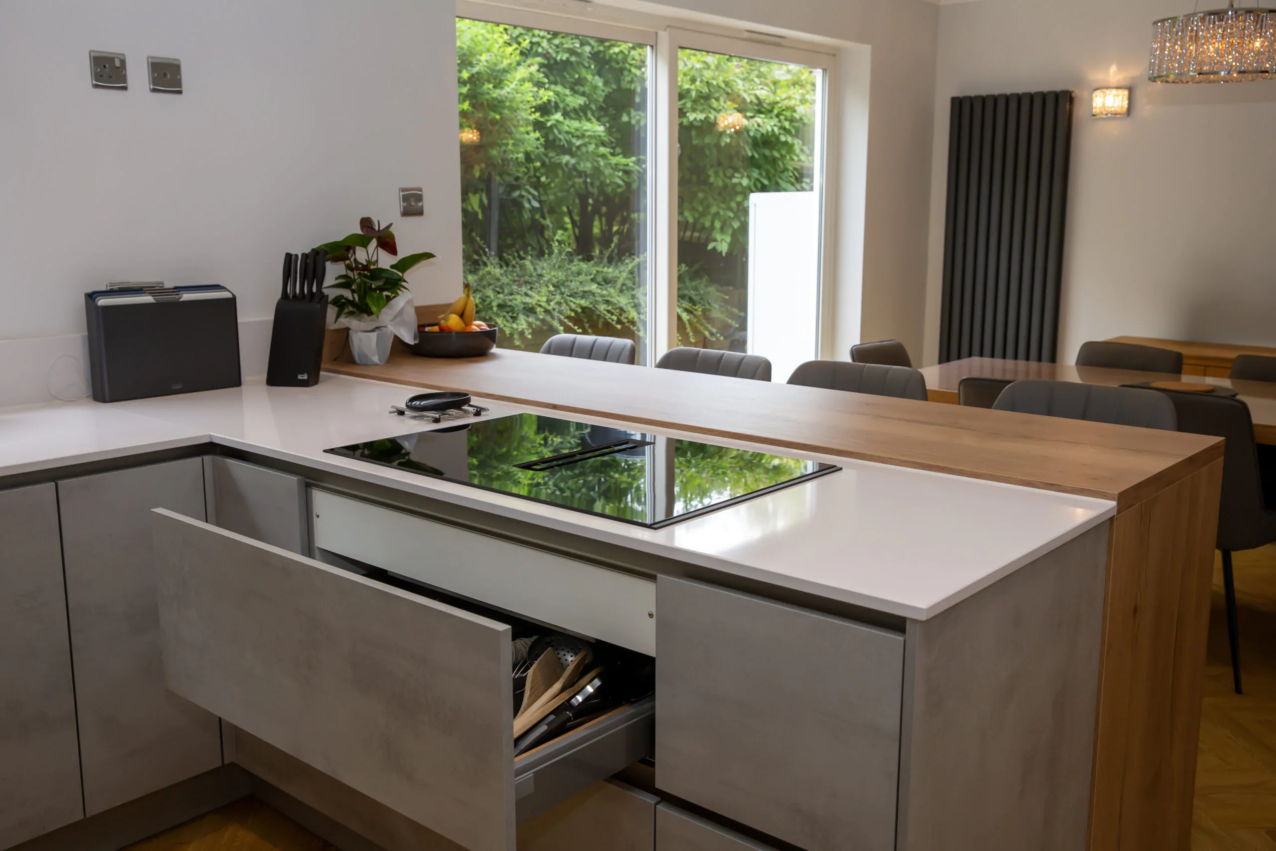 Integrated cooktop and countertop space in a contemporary kitchen with stone-effect cabinets
