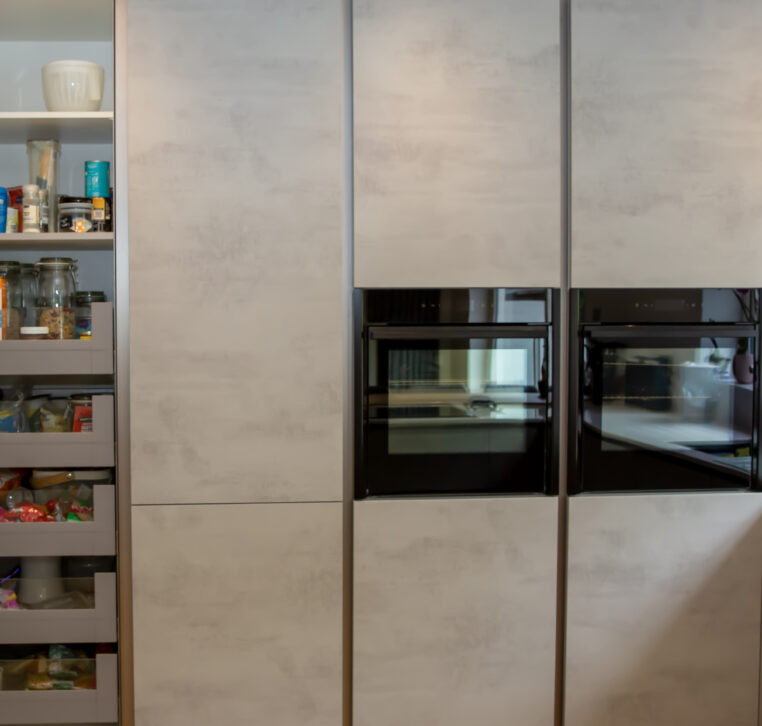 Minimalist grey kitchen cabinets with a built-in oven and sleek design