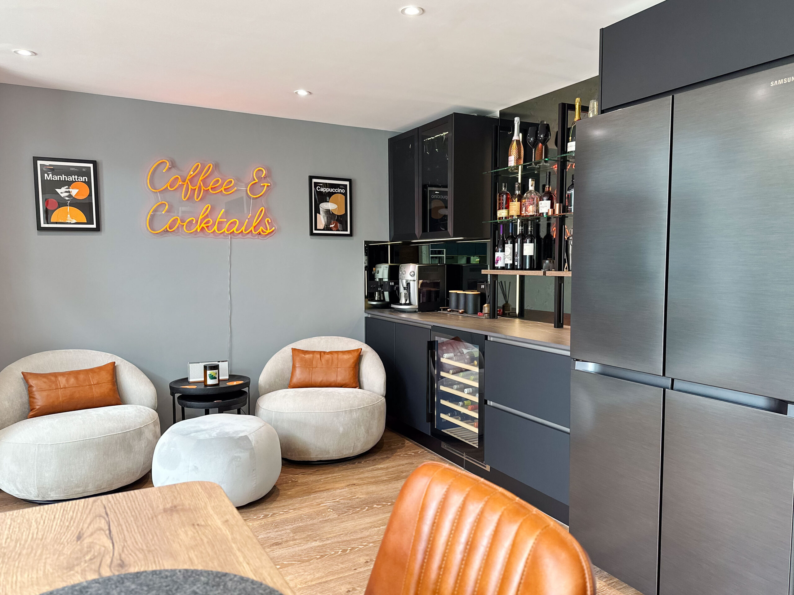 Cozy cocktail lounge area adjacent to the kitchen, featuring wine cooler, built-in bar, and stylish decor.
