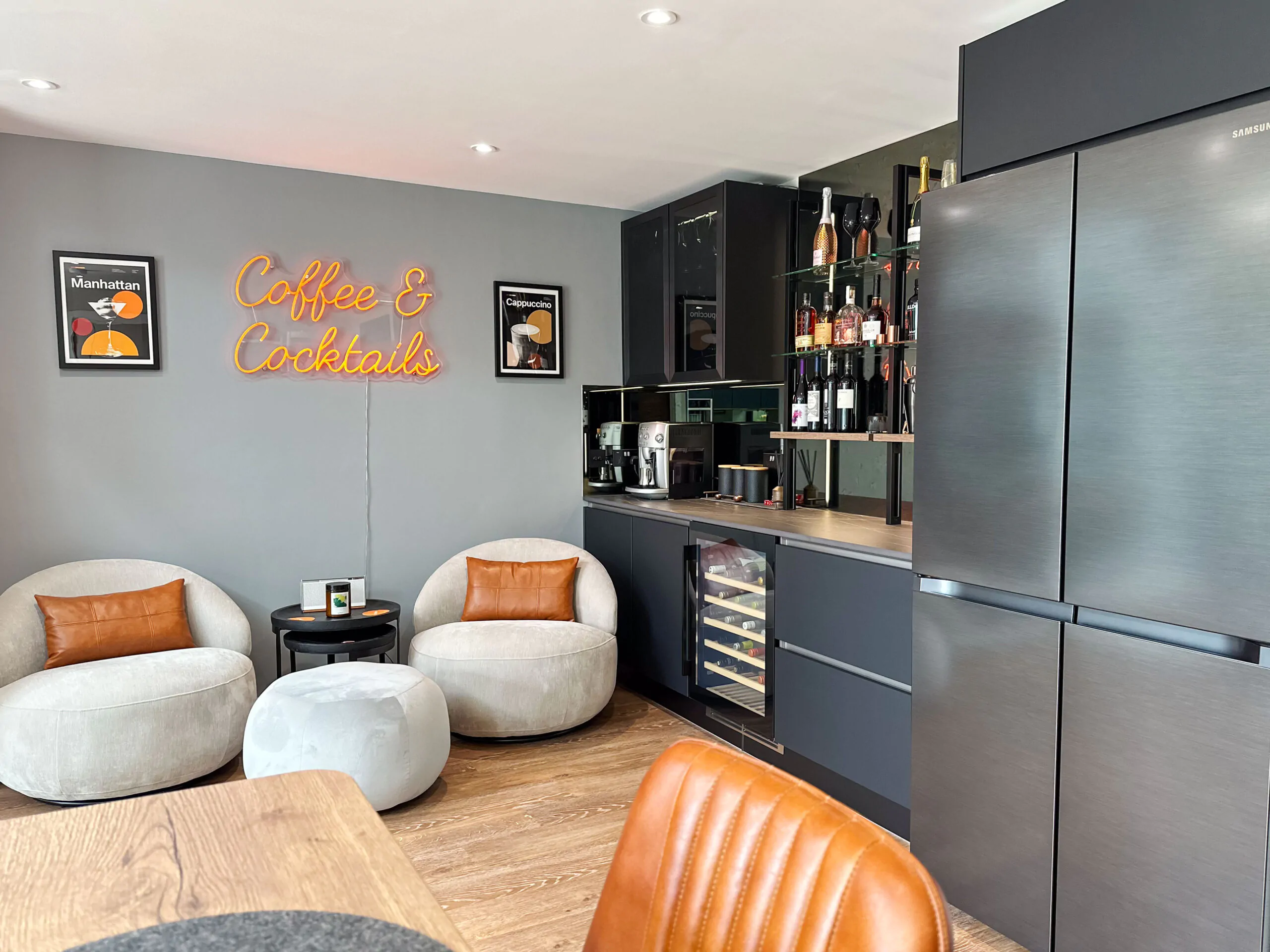 Cozy cocktail lounge area adjacent to the kitchen, featuring wine cooler, built-in bar, and stylish decor.