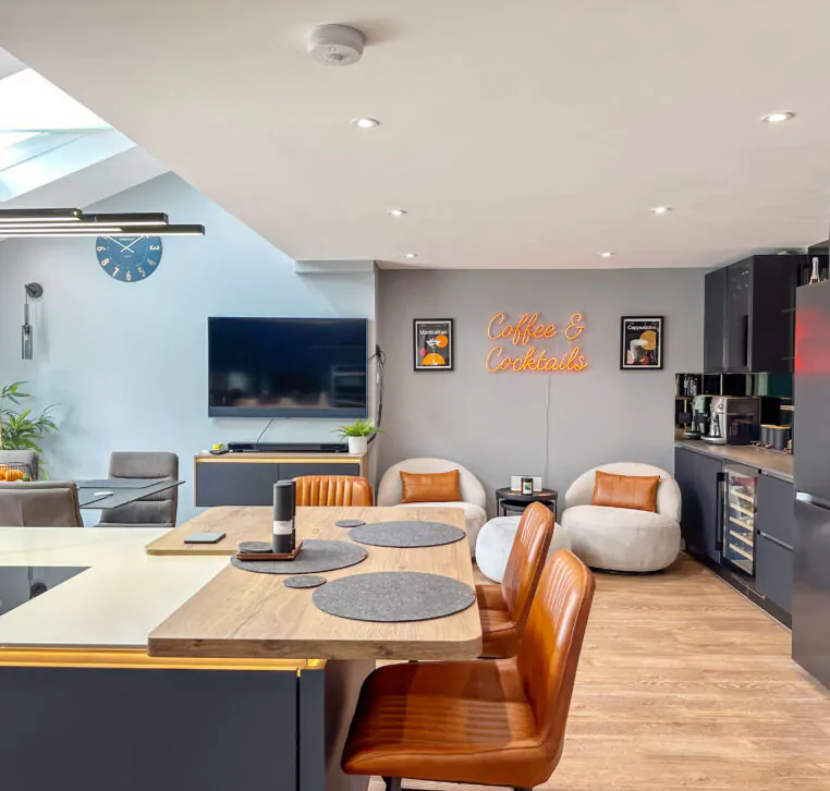 Full view of the open-plan kitchen with large island, skylights, and integrated dining area.