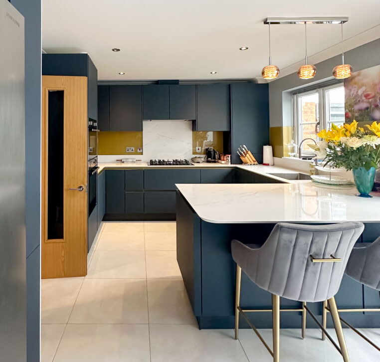 luxurious U-shaped kitchen with a peninsula and gold Line N cabinetry