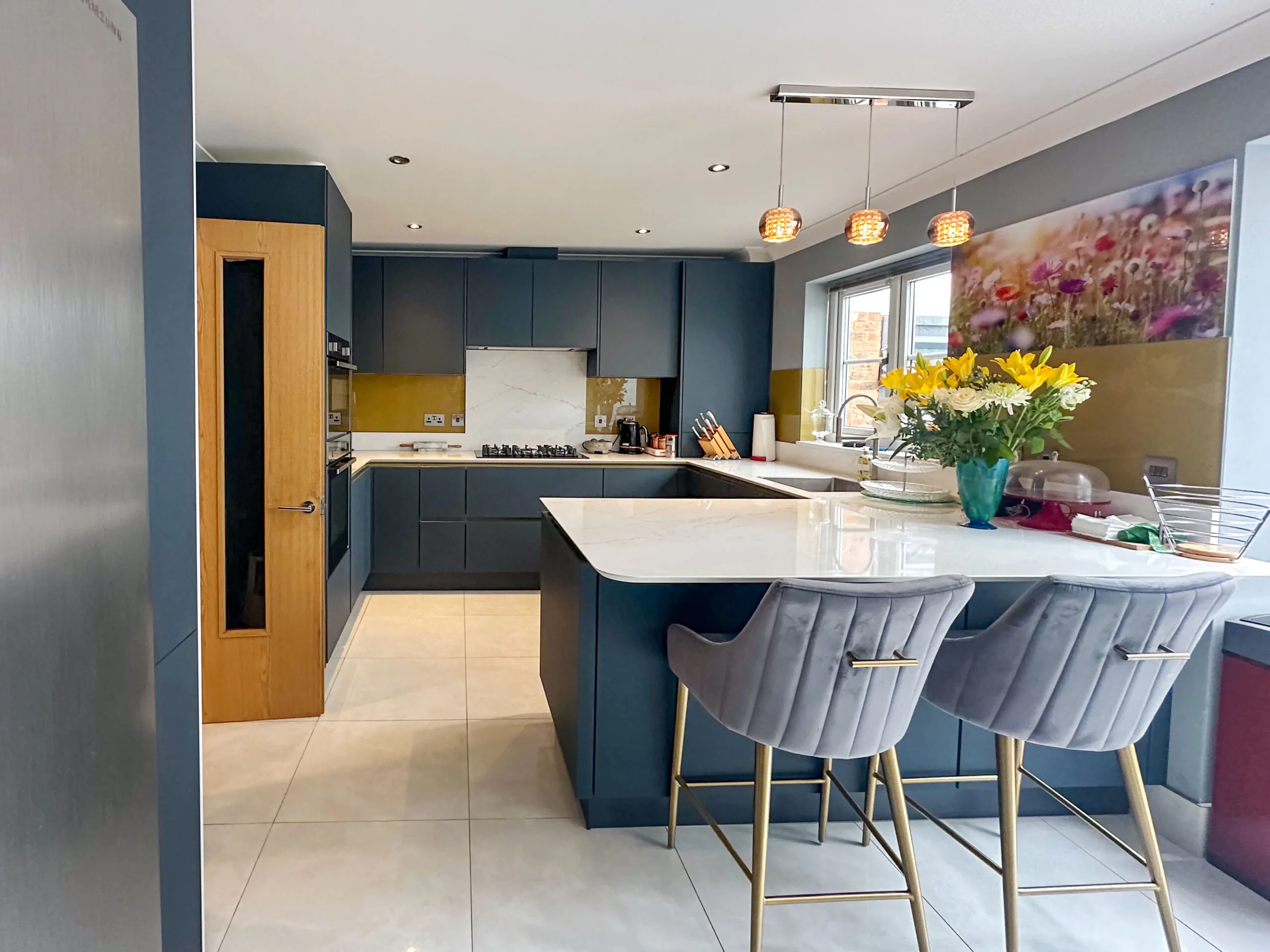 Modern kitchen with gold Line N cabinets, American-style fridge freezer, and integrated storage