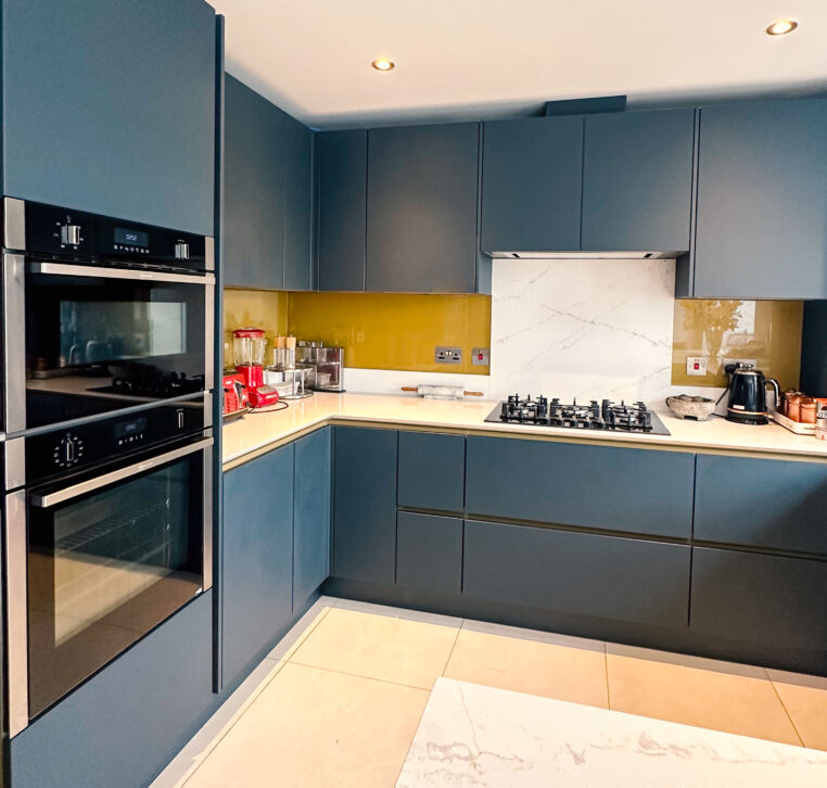 luxurious U-shaped kitchen with a peninsula and gold Line N cabinetry