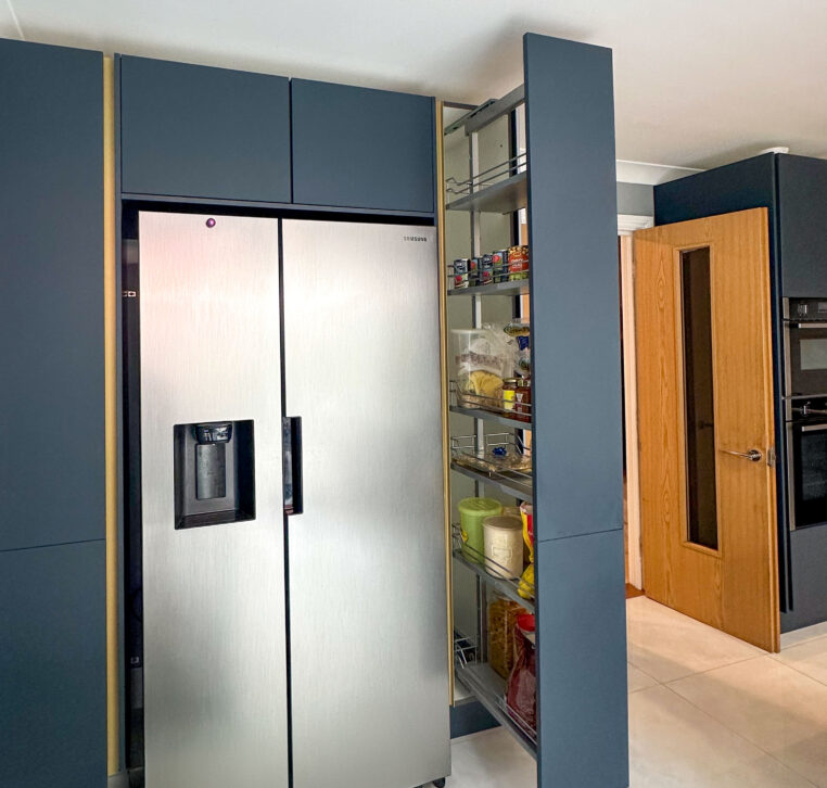 Pantry pull-out system with American-style fridge freezer in a gold Line N kitchen