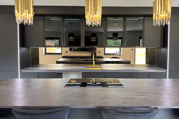 Elegant, Sleek Black & Gold Kitchen with Quartz Island