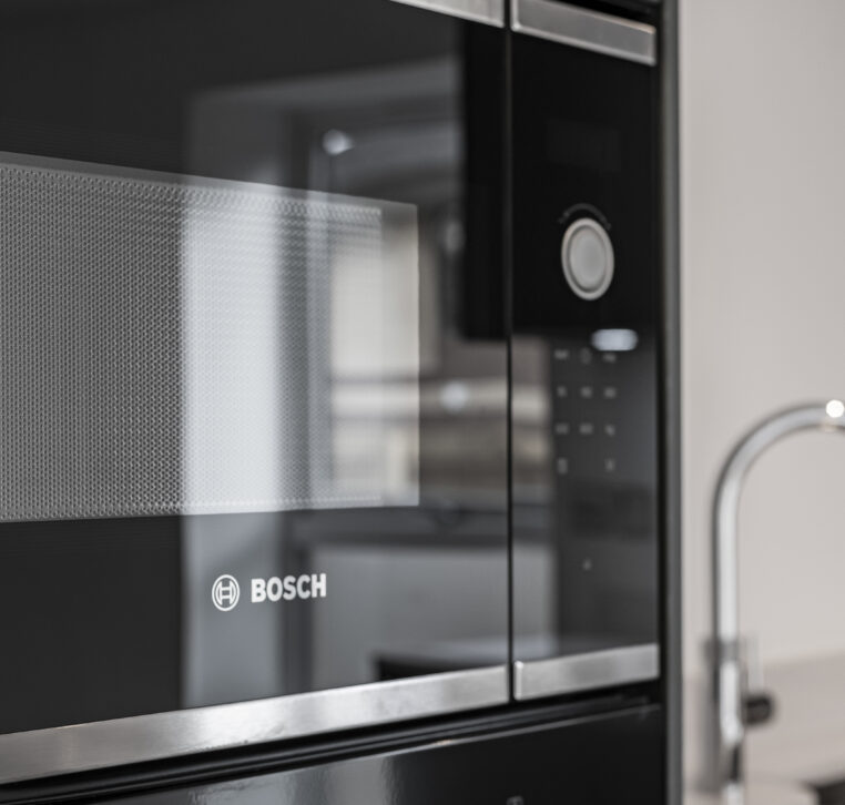 Close-up of Bosch integrated microwave in a modern contract kitchen