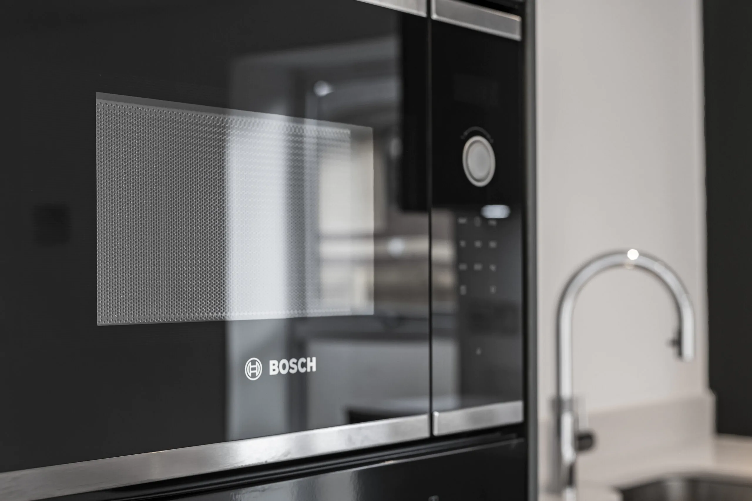 Close-up of Bosch integrated microwave in a modern contract kitchen