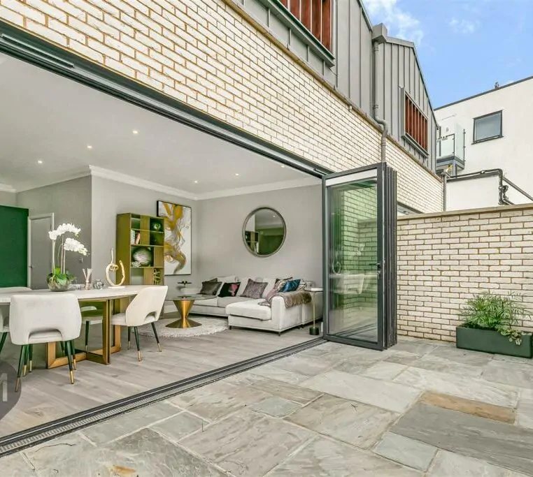 Indoor-outdoor living space featuring large sliding doors and contemporary design in a Camborne Mews home
