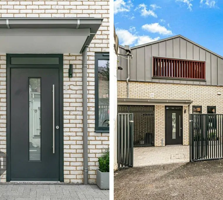 Close-up view of a modern entrance with dark door and brick facade at a residential project in Camborne Mews, London
