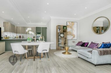 -plan living and dining area with stylish furnishings and light wood flooring in a 3-bed home at Camborne Mews, London