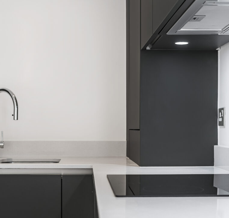Modern kitchen with dark cabinetry and chrome faucet