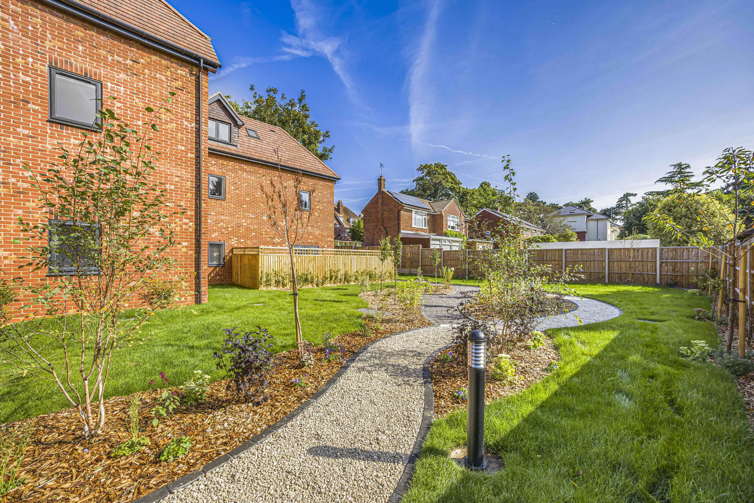 Landscape garden area with curved winding pathways surrounding a new-build residential development in Reading