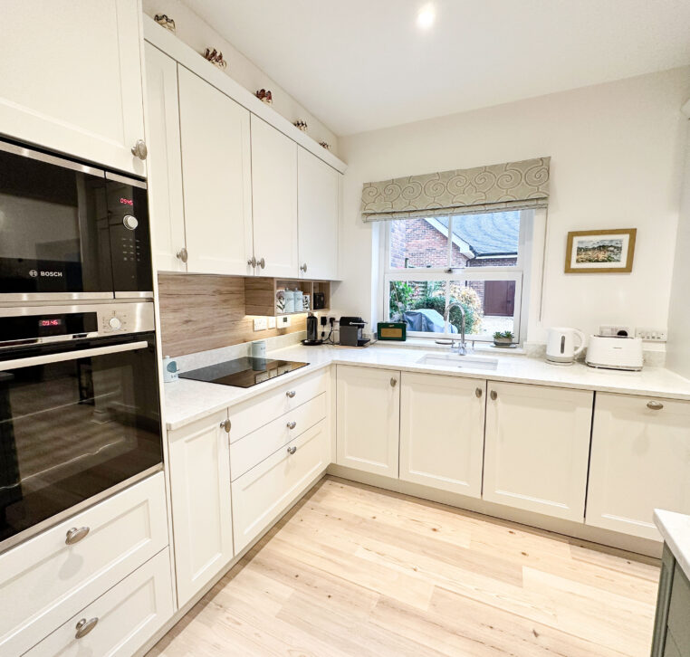 Modern shaker kitchen with quartz worktop and Sanremo Oak upstand for warmth