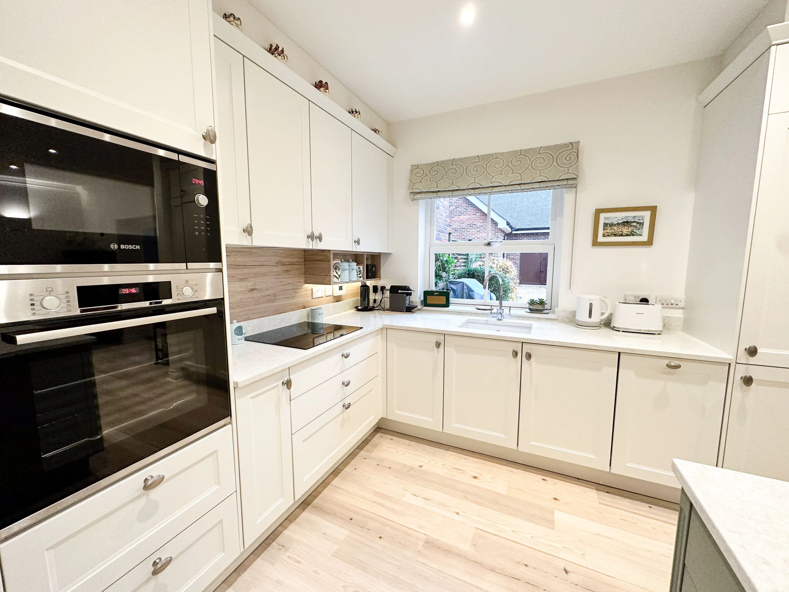 Modern shaker kitchen with quartz worktop and Sanremo Oak upstand for warmth