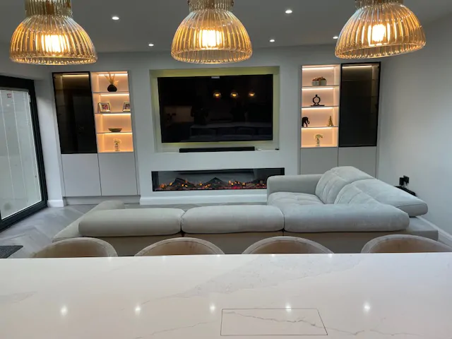 Modern open-plan kitchen and living area with large seating island and pendant lights