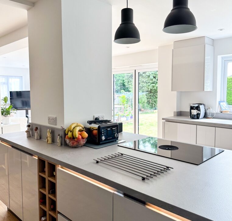 Close-up of a modern kitchen island featuring a sleek induction hob and black toaster