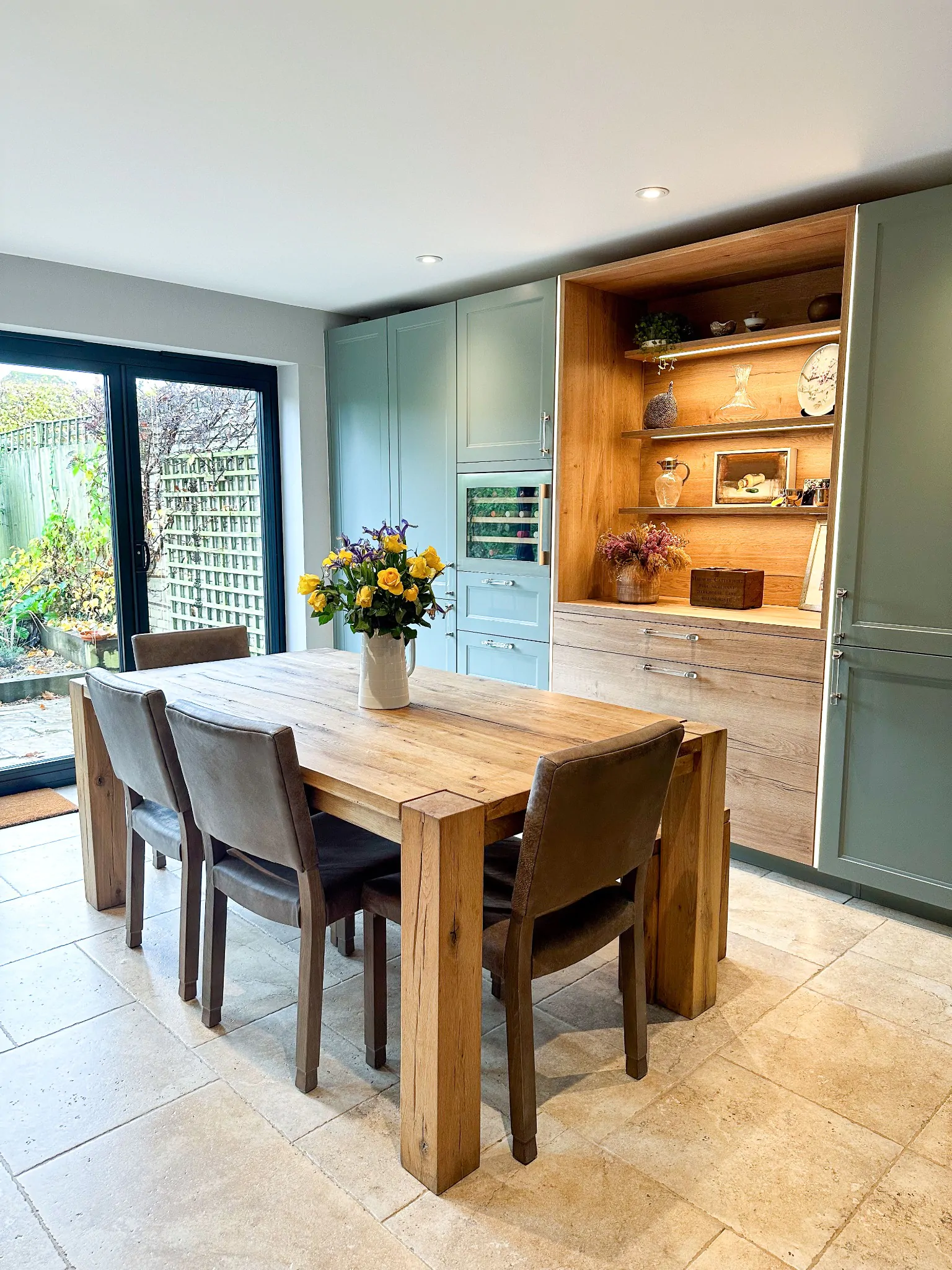 Large kitchen refrigerator integrated into a modern wood shaker design with double doors