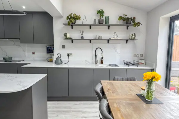 Modern Grey Kitchen with White Quartz Worktops, Sleek Island, and Integrated Appliances