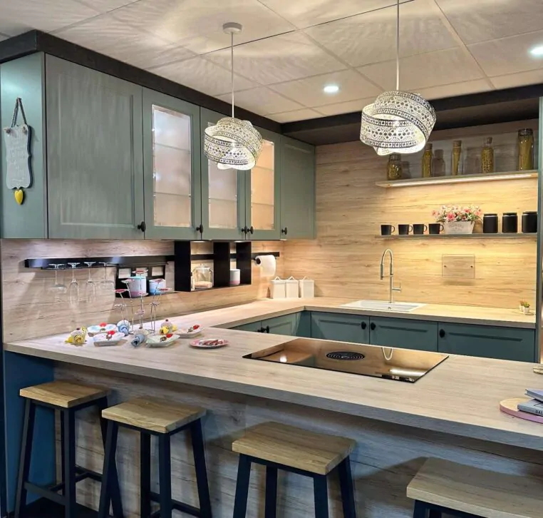 Contemporary green kitchen with open shelving, light wood countertop, and modern appliances.