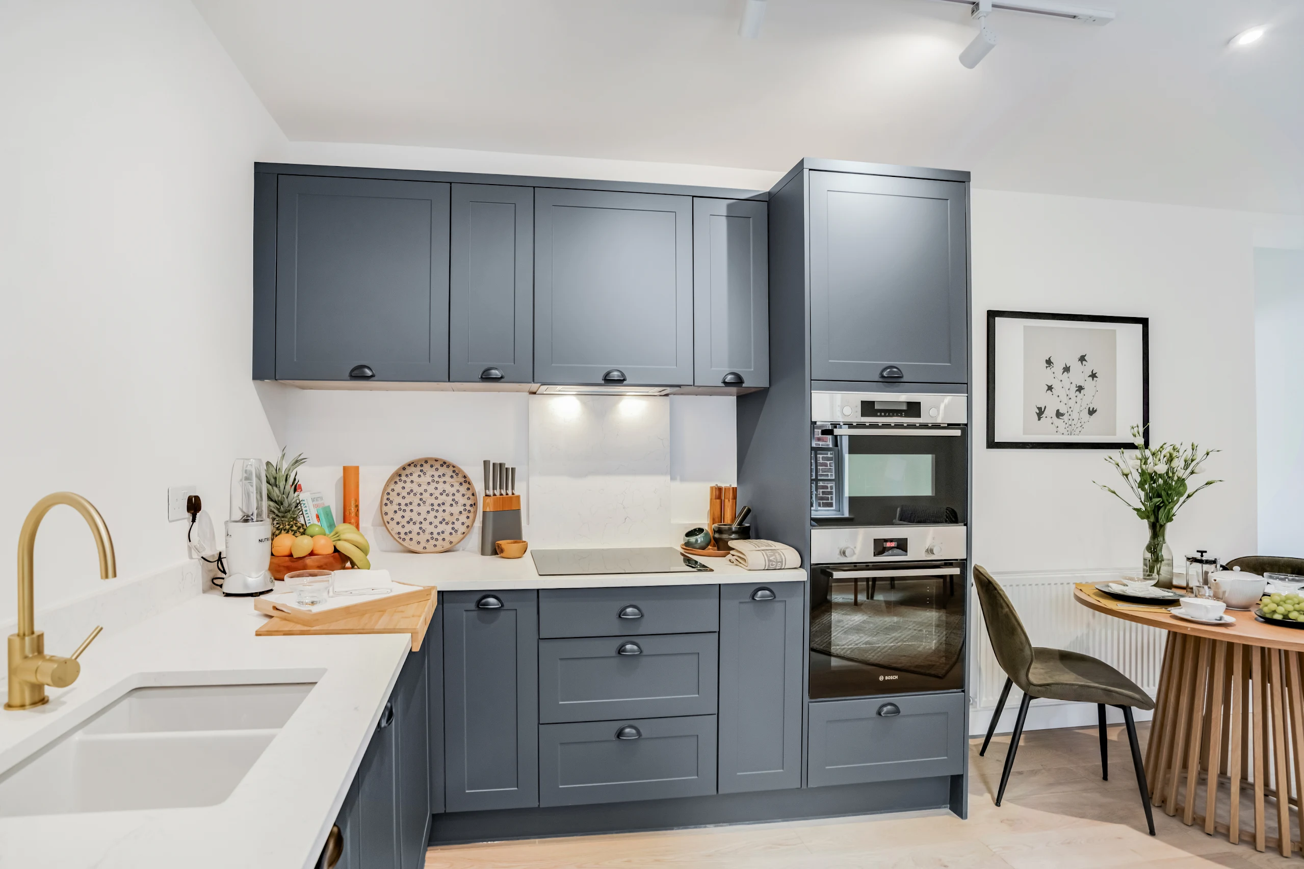 Wide shaker kitchen with bright finishes and generous storage