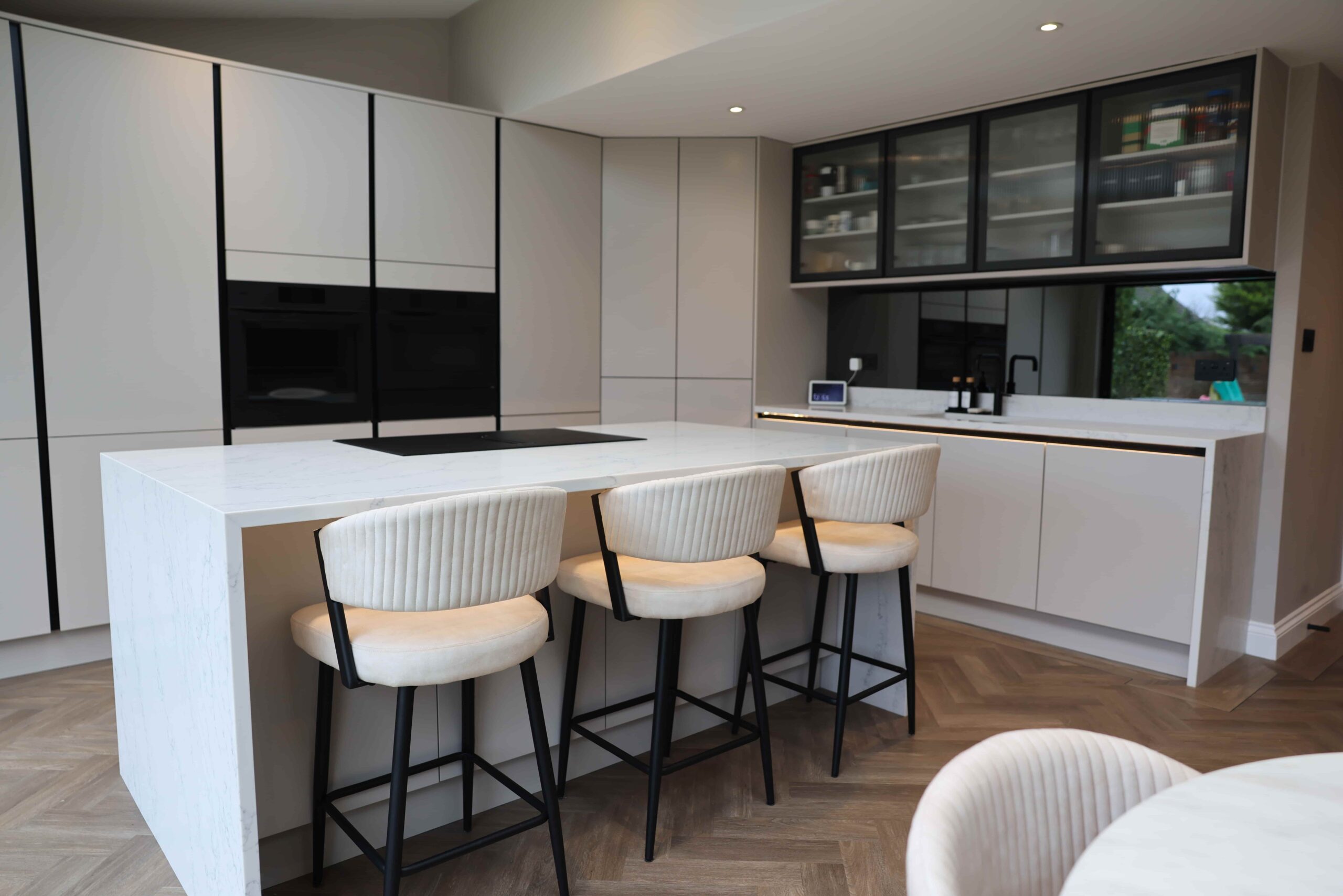 Contemporary White Handleless Kitchen with Statement Island & Glass Cabinets