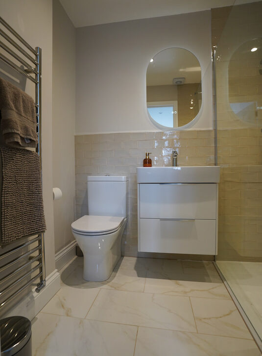 Compact bathroom with vanity unit, WC, and walk-in shower.