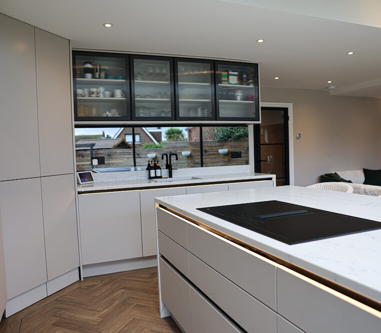 black glass cabinets in handleless kitchen