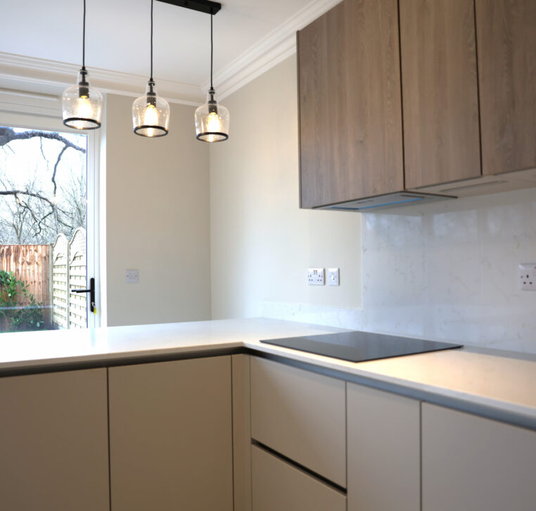 Modern kitchen with breakfast bar and patio doors creating a bright open living space in Reading home