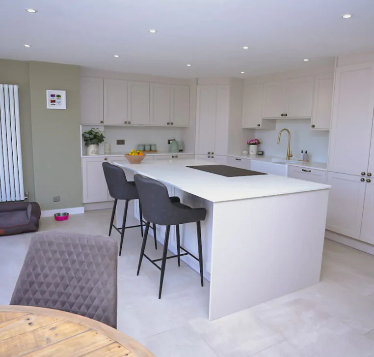 Bespoke shaker kitchen featuring a large breakfast island, integrated storage and neutral finishes by MAS Collection.