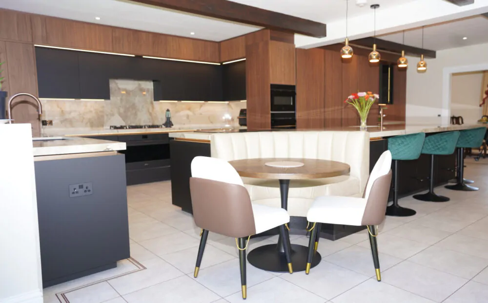 Handleless U-shaped kitchen with white cabinets and wood accents, completed by MAS Collection in Reading.