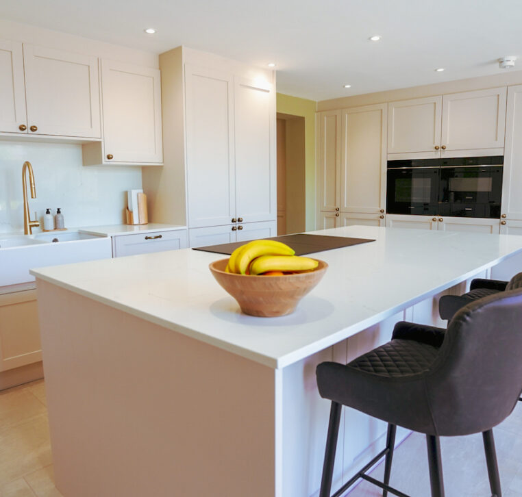 Luxury shaker kitchen with large island, integrated appliances and elegant neutral finishes by MAS Collection.