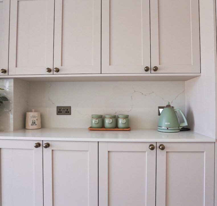 Shaker kitchen pantry storage with quartz splashback and neutral cabinetry designed by MAS Collection.